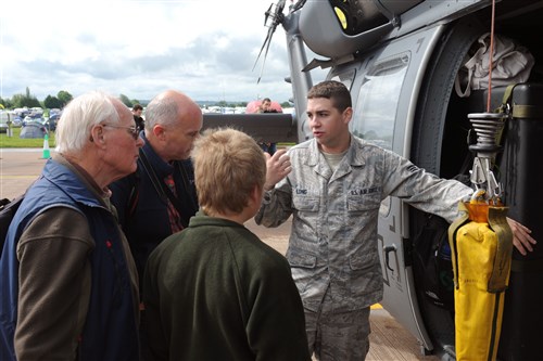 RAF FAIRFORD, United Kingdom - Senior Airman Kenneth Long talks about the capabilities of the HH-60 Pave Hawk during the Royal International Air Tattoo July 7. Long is assigned to the 748th Aircraft Maintenance Squadron at RAF Lakenheath, United Kingdom. 