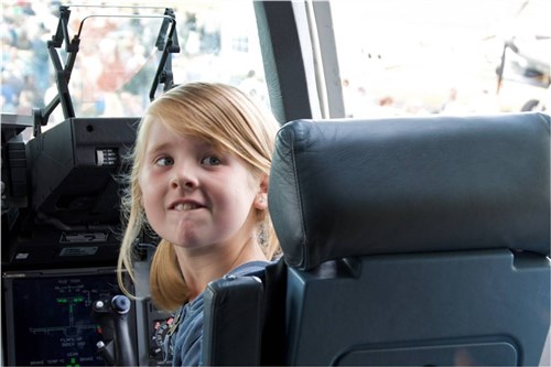 FARNBOROUGH, United Kingdom -- A small child looks astonished by the cockpit features of a C-17 Globemaster at  the 2010 Farnborough International Air Show July 25.  The utility helicopter and crew traveled from Travis Air Force Base, Calif., to participate in this year's show allowing approximately 285,000 spectators to tour their aircraft. (U.S. Air Force photo by Col. Robert Suminsby)