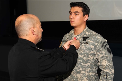 U.S. European Command Commander Admiral James G. Stavridis pins the Bronze Star with Valor device on Staff Sgt. Jeffery Musgrave during a Valor Ceremony hosted by U.S. Special Operations Command Europe on Dec. 6, 2011 in Stuttgart, Germany. Musgrave, a U.S. Army Special Forces Soldier assigned to 1st Battalion, 10th Special Forces Group (Airborne), received the fourth-highest award for gallantry in combat for his heroic actions on May 17, 2010 in Wardak Province, Afghanistan in direct support of Operation Enduring Freedom. He also received the Purple Heart for his actions and wounds received by the enemy.