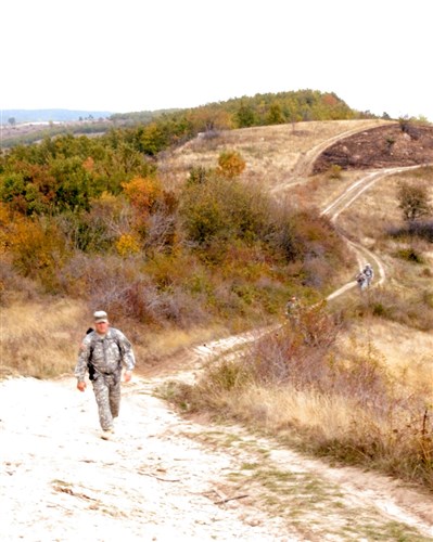 1st Sgt. William Fippen, Task Force Aviation, Multinational Battle Group East, climbs a mountain trail in Kosovo, Oct. 10, during the Dancon March, a 26-kilometer (16-mile) course that is a tradition for the Danish military. The Dancon March has been held each year since 1972 wherever the Danish military is stationed, and has been held in Kosovo, Afghanistan and Iraq. More than 580 service members from several countries participated in this event, the first of three scheduled Dancon Marches this Fall. (U.S. Army photo by Staff Sgt. Jordan E. Werme, 130th Public Affairs Detachment, Connecticut National Guard)