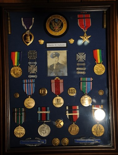 A shadowbox holds many decorations and uniform accouterments earned by Army Pfc. Charles W. Eubanks for his service in World War II.