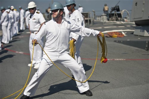 HAIFA, Israel - Boatswain's Mate 3rd Class Ron Welch throws heaving line to a tugboat as the guided-missile destroyer USS Jason Dunham (DDG 109) prepares to enter port in Haifa to take part in Exercise Reliant Mermaid 2012. This is the 11th iteration of Reliant Mermaid, an annual search and rescue exercise designed to increase interoperability by developing individual and collective maritime proficiencies of participating nations, as well as promoting friendship, mutual understanding and cooperation.