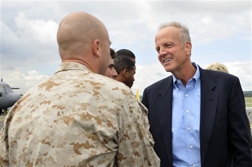 Kansas Sen. Jerry Moran is greeted by U.S. Marine Corps Staff Sgt. George Singer, Marine Medium Tiltrotor Squadron 264 tool room staff non-commissioned officer in charge, July 8, 2012, during the Farnborough International Air Show in Farnborough, England. Approximately 100 aircrew and support personnel from bases in Europe and the U.S. are participating in the air show. The world renowned event exhibits the latest in aerospace equipment and technology.