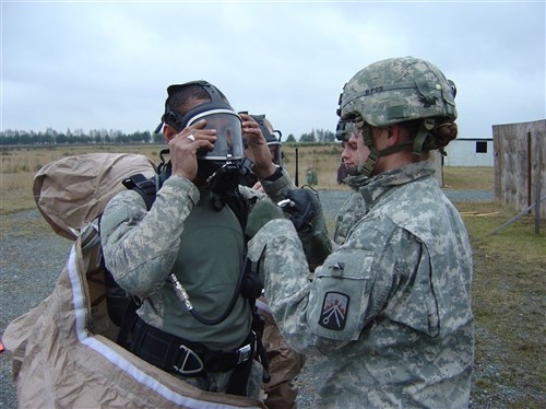 GRAFENWOEHR, Germany &mdash; Soldiers from the 12th Chemical Company, 18th Combat Sustainment Support Battalion, 16th Sustainment Brigade, prepare for training by donning personal protective equipment. The &#34;Hellfire&#34; company performed multiple battle drills including a live fire exercise during a 14-day field training exercise recently. (U.S. Army photo)