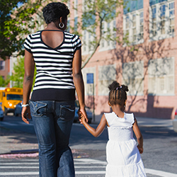 Mother and daughter walking hand in hand.