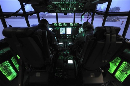 Lt. Col. Joshua Olson, 37th Airlift Squadron commander, and Capt. Marci Walton, 37th Airlift Squadron instructor pilot, go through the pre-flight checklist in the flight deck of a C-130J Super Hercules, March 16, 2012 at Ramstein Air Base, Germany. The 37th AS completed a week-long airdrop training exercise with a ten-bundle container deployment system at a drop zone near Grafenwoehr, Germany. 