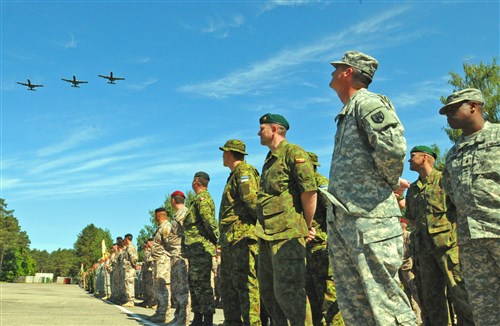 Soldiers, Airmen and Marines from eight different nations, stand together in a formation and watch as three Airforce A10 Warthogs perform a flyover during an opening ceremony for Exercise Saber Strike 2012 on Latvian Army Camp Adazi in Latvia June 10. Saber Strike 2012 is a U.S. Army Europe led theater security cooperation exercise conducted in the Baltic States. One of the major goals of the exercise is to improve NATO interoperability and strengthens the relationship between military forces of the U.S., Baltic nations and other participating nations.