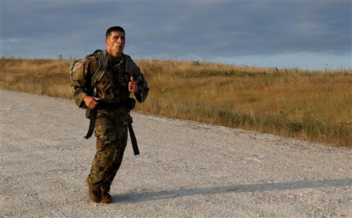 Staff Sgt. Oscar Morales, an infantryman and Arizona Army National Guardsman assigned to the 2nd Assault Helicopter Battalion, 285th Aviation Regiment, conducts a 12-mile ruck march on Camp Bondsteel, Kosovo, during the Multinational Battle Group-East's Best Warrior Competition July 10. (U.S. Army photo by: Staff Sgt. Thomas Duval, Multinational Battle Group-East Public Affairs)