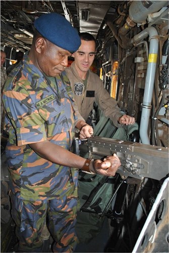 CAMP LEMONNIER, Djibouti - Kenya Air Force Base Sergeant Major Maurice Atsango Matwang'a examines a .50 caliber machine gun during a tour of a CH-53E Super Stallion helicopter given by U.S. Marine Corps Staff Sergeant Dustin Silvey, a crew chief with Marine Heavy Helicopter Squadron 461, March 27, 2012. Matwang'a, along with three other Kenyan Ministry of Defense senior enlisted leaders, visited their Combined Joint Task Force - Horn of Africa counterparts to exchange best practices and enhance understanding of the enlisted leadership roles and responsibilities that effect mission execution. (U.S. Navy photo by Chief Petty Officer Maria R. Escamilla)