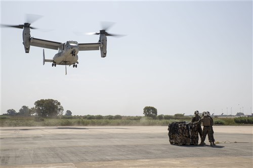 Landing support specialists with Combat Logistics Battalion 2, Special Purpose Marine Air-Ground Task Force-Crisis Response-Africa, await the arrival of an MV-22B Osprey during a helicopter support team exercise aboard Naval Station Rota, Spain, July 6, 2016. This training prepares Marines to deliver and recover supplies quickly and efficiently in potential future missions across Europe and Africa. (U.S. Marine Corps photo by Staff Sgt. Tia Nagle/Released)