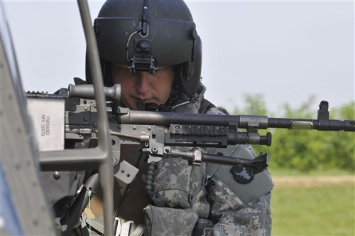 RAMJAN/RAMIJANE, Kosovo &mdash; Army Staff Sgt. Matt Singer, of Simpsonville, Ky., attaches a M-240B machine gun to an Army UH-60 Blackhawk helicopter prior to qualifying for aerial gunnery near Ramjan/Ramijane, Kosovo, during annual soldier skill training May 3-5.  (U.S. Army photo by Sgt. Joshua Dodds)
