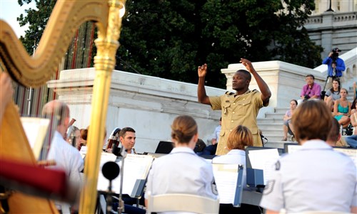 BOLLING, Washington, D.C. - Captain Patrick Odjo, commander of the Music Squadron and Mobile Squadron for the National Gendarmerie in Benin, was a guest conductor for the U.S.Air Force Band as they played for bystanders on the steps of the U.S. Capitol building on July 24, 2012 in Washington D.C. The band hosts this concert every Tuesday from June 5-August 28. (Air Force photo by Senior Airman Christina Brownlow)