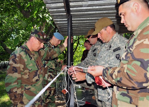 Moldovan engineers and soldiers of North Carolina National Guard’s 430th Explosive Ordnance Disposal (EOD) Company practice tying demolition knots. For three weeks, Moldovan engineers and soldiers of the 430th trained side-by-side and shared the latest tactics, techniques and procedures in eliminating landmine hazards in order to return the land to productive economic use and development.
