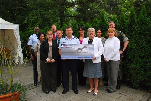 STUTTGART, Germany - Renee Acosta (front, right), president and CEO of Global Impact, Principal Combined Fund Manager for Combined Federal Campaign Overseas, presents a check for more than 11,000 dollars to U.S. Africa Command Chief of Staff Major General Michael A. Snodgrass (front, center). The money, donated by U.S. Africa Command staff during the 2008 Combined Federal Campaign (CFC), will go towards the Family Support and Youth Programs in the Stuttgart community. Also represented is CFC Overseas Campaign Deputy Director Constance Baker (front left) and U.S. Africa Command team members of the CFC campaign, representing each participating directorate. CFC, the world&#39;s largest and most successful annual workplace charity campaign, allows federal civilian, postal, and military personnel to support eligible non-profit organizations that provide health and human service benefits throughout the world. (Photo by Petty Officer 1st Class Daniel P. Lapierre, U.S. Africa Command)