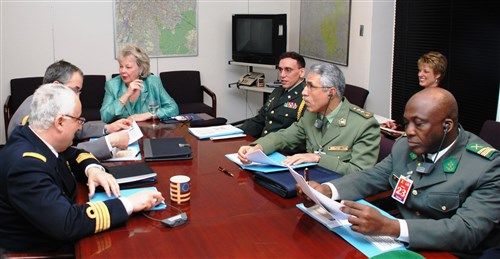 BRUSSELS, Belgium - Ambassador Mary Carlin Yates, U.S. Africa Command&#39;s deputy to the commander for civil-military activities (seated at head of table), explains U.S. AFRICOM activities to African defense attaches to Belgium, March 12, 2009, in Brussels. Yates spoke with defense attaches from Benin, Algeria, Tunisia, Morocco, Egypt and South Africa. She also met with Belgian defense and foreign affairs officials to share information about command activities and discuss possibilities for future cooperation.  From left to right: Benin Army Colonel Idrissous Latoundji; Algerian Army Colonel Miloud Lakhdari; U.S. Defense Attache to Belgium Colonel Dan Fagundes; Yates; Moroccan Navy Colonel Adderrahim Guerrouaz; and Tunisian Navy Captain Habib Boughoula. (U.S. Africa Command photo by Kenneth Fidler)