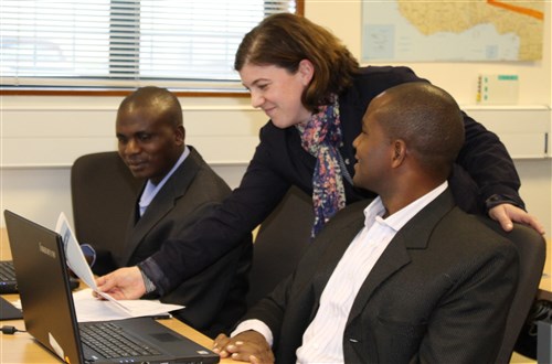 Captain John Bernard Kivunge (right) and Captain YL Kebero from the Tanzanian Peopleeâs Defense Forces (TPDF) with Nikki Decie,  an instructor at the Regional Joint Intelligence Training Facility (RJITF)during the Instructor Development Course (IDC) taught at the at RAF Molesworth this week.  (Photo by Melony Angelilli)