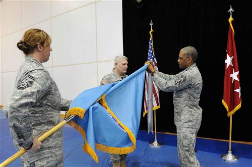 STUTTGART, Germany - General Carter Ham, Commander of U.S. Africa Command and Chief Master Sergeant Jack Johnson Jr., U.S. Africa Command's senior enlisted leader, attach the first streamer for USAFRICOM colors, March 9, 2012. The Command was awarded the Joint Meritorious Unit Award streamer for their response to the conflict in Libya between March 19 and March 30, 2011. During this time, the command coordinated humanitarian and military operations to maintain stability in the region, established a no-fly zone over Libya, and enforced an arms embargo at sea. (U.S. AFRICOM photo by Angeline Hoffmann)