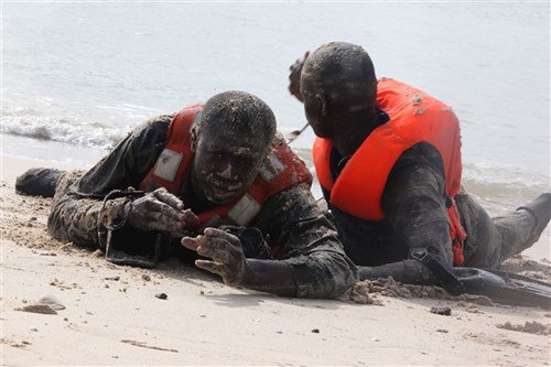 Senegalese Companie de Fusilier Marine Commandos swim ashore ensuring the beach is clear of an enemy or obstacles on Bel Air Naval Base in Dakar, Senegal, after being taught by Marines and sailors with Special-Purpose Marine Air-Ground Task Force Africa 13 Aug. 16, 2013. Special-Purpose MAGTF Africa strengthens U.S. Marine Corps Forces Africa and U.S. Africa Commands ability to assist partner nations in theater security cooperation and military-to-military engagements. Special-Purpose MAGTF Africa’s current iteration is the fourth rotation working with the Senegalese Forces. (U.S. Marine Corps photo by Cpl. Ryan Joyner/Released)