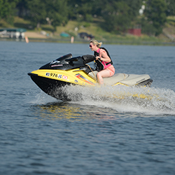 Woman riding personal watercraft.