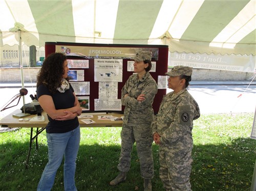 Left to right -Michelle Sanders, malaria survivor, Lt. Col. Pamela Ward-Demo and Lt. Col. SueAnn Ramsey from the Command Surgeon's Office talk about World Malaria Day. The U.S. Africa Command observed World Malaria Day at Kelley Barracks on April 25, 2014 to help spread awareness of malaria to members of the AFRICOM community.