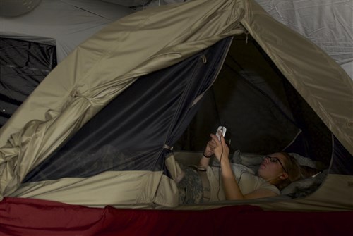 Pfc. Stephanie Scales, a mechanic assigned to the 194th Military Police Company, Joint Forces Command-United Assistance, rests inside of her tent after work at Barclay Training Center, Monrovia, Liberia, Dec. 2, 2014. The tents and mosquito nets are part of the equipment issued to U.S. troops in order to protect them against malaria. Operation United Assistance is a Department of Defense operation in Liberia to provide logistics, training and engineering support to U.S. Agency for International Development-led efforts to contain the Ebola virus outbreak in western Africa.