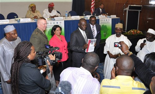 The Nigerian Minister of Foreign Affairs, Dr. Nurudeen Muhammad, displays the unveiled National Pandemic Preparedness and Response Plan for members of the media during a ceremony held in Abuja, Nigeria, November 14, 2013. He is flanked on the left by Maria Brewer (pink jacket), U.S. Embassy Abuja’s Deputy Chief of Mission, and U.S. Marine Lt. Gen. Steven Hummer, Deputy to the Commander for Military Operations, U.S. Africa Command.  Right of Dr. Muhammad is Professor C.O. Onyebuchi Chukwu, the Nigerian Minister of Health.  The event was attended by more than 150 disaster response civil and military experts and leaders from Nigeria, Burkina Faso, Ghana, Kenya, Senegal, Uganda, Liberia, Mozambique, and international organizations.  The ceremony was followed by a disaster response exercise sponsored by U.S. Africa Command with the support of the Center for Disaster and Humanitarian Assistance Medicine (CDHAM). (Photo by TSgt Olufemi Owolabi, U.S. AFRICOM Public Affairs/Released)