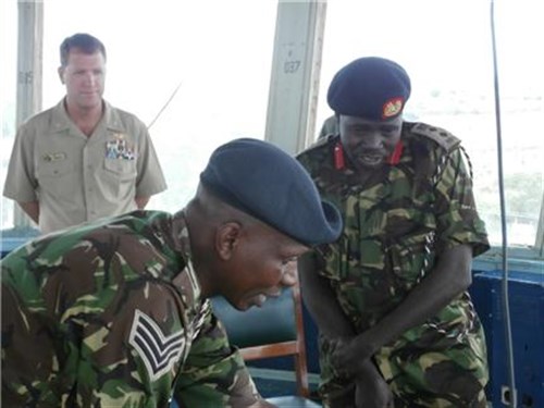 U.S. Navy Capt. Timothy Sheridan (left) and Kenyan Defense Forces (KDF) Col. Ngirithia Lekaunye (right) look on as a KDF soldier operates a TMQ-53 Tactical Meteorological Observing System at the Kenyan Military Airport in Nairobi Aug. 24, 2013. The system assists war planners and combat weather teams through a collection of weather sensors. Combined Joint Task Force â Horn of Africa supports partner nations in military-to-military engagements to defeat violent extremist organizations in East Africa. (Courtesy Photo)