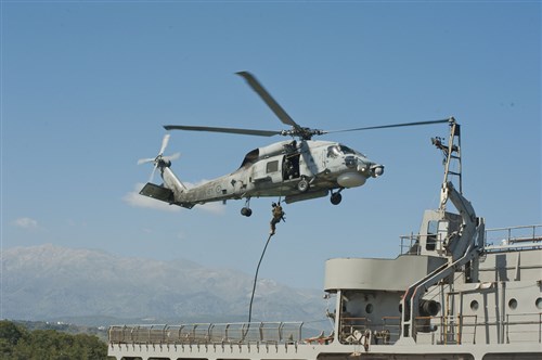 An Algerian boarding team member fast ropes out of a Greek helicopter onto the NATO Maritime Interdiction Operational Training Center (NMIOTC) ship "Aris" during the pre sail phase of Exercise Phoenix Express 2014. Phoenix Express is a U.S. Africa Command-sponsored multinational maritime exercise between North African, European and U.S. naval forces designed to increase maritime safety and security in the Mediterranean Sea. (U.S. Navy photo by Mass Communication Specialist Seaman Mat Murch)