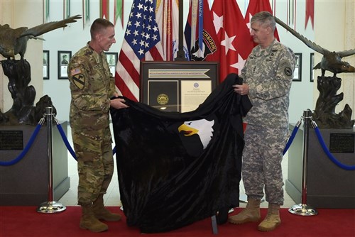 From right: Gen. David M. Rodriguez, commanding general, U.S. Africa Command, and Maj. Gen. Gary J. Volesky, commanding general, 101st Airborne Division (Air Assault) and Fort Campbell, unveil the Joint Meritorious Unit Award during a ceremony at McAuliffe Hall August 27, 2015. The JMUA, the second most prestigious award a unit can receive, was presented to the 101st Airborne Division for their humanitarian mission during the Ebola epidemic in Liberia. (U.S. Army photo by Jerry Woller, Lead VI Specialist-Fort Campbell)