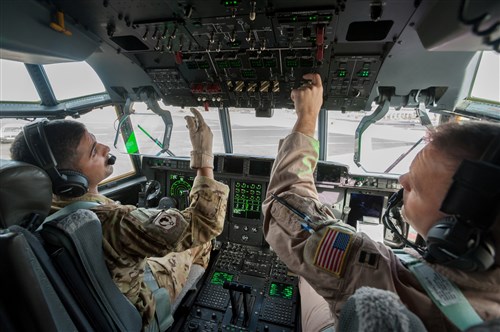 U.S. Air Force Capts. Vincent Levraea (left) and Jason Steinlicht, both pilots from the 317th Airlift Group at Dyess Air Force Base, Texas, conduct pre-flight checklists at Léopold Sédar Senghor International Airport in Dakar, Senegal, Nov. 4, 2014. The pilots are preparing to fly a sortie into Monrovia, Liberia, to deliver more than 8 tons of humanitarian aid and military supplies in support of Operation United Assistance, the U.S. Agency for International Development-led, whole-of-government effort to contain the Ebola virus outbreak in West Africa. (U.S. Air National Guard photo by Maj. Dale Greer/Released)