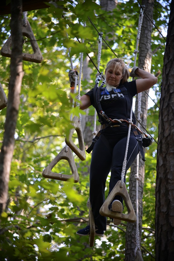 VIRGINIA BEACH, Va. (October 08, 2015) — A participant of the Navy Information Dominance Forces Senior Leadership Development Program (SLDP) navigates across a portion of the aerial trail at The Adventure Park at Virginia Aquarium, Virginia Beach, Va. during a one-day skill-building event. The one-day skill-building event is part of a 10-month course based on the Office of Personnel Management's (OPM) five Executive Core Qualifications: Leading Change, Leading People, Results Driven, Business Acumen and Building Coalitions. U.S. Navy photo by Michael J. Morris 