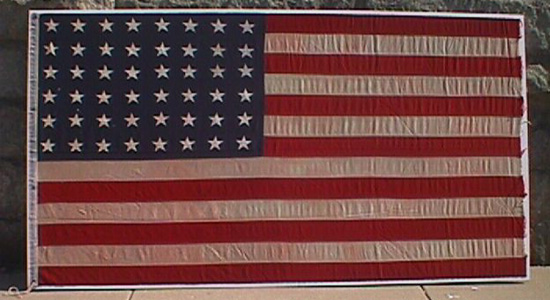 The United States 48-star national flag flown on USS Pirate (AM 275), circa 1950. The flag went down when USS Pirate struck a mine and sank Oct. 12, 1950, but showed up in an anonymous package sent to the ship’s former commanding officer two years later. NHC catalog number 85-133-A. Photo courtesy of NHHC.