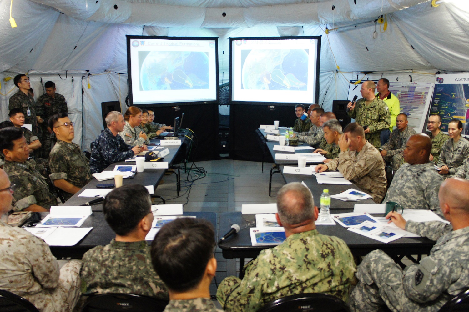 Aerographer's Mate 2nd Class Howard Bigby, assigned to the strike group oceanography team from Fleet Weather Center San Diego, provides the morning weather update to U.S. Rear Adm. Daniel Fillion and Republic of Korea Rear Adm. Park, Ki Kyung during the Combined Joint Logistics Over-the-Shore (CJLOTS) 2015 commander's update brief. CJLOTS is an exercise designed to train U.S. and Republic of Korea service members to accomplish vital logistical measures in a strategic area while strengthening communication and cooperation in the U.S.-Republic of Korea Alliance. U.S. Navy photo by LT Russell Wolfkiel