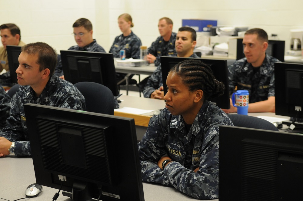  PENSACOLA, Fla. (Aug. 28, 2015) Officers attending the Information Professional Basic Course at Center for Information Dominance Unit Corry Station listen to Rear Adm. Daniel J. MacDonnell, commander of Information Dominance Corps Reserve Command (IDCRC) and Reserve deputy commander of Navy Information Dominance Forces (NAVIDFOR). Macdonnell spoke with them about career opportunities in the Information Dominance Corps and active and reserve integration.  U.S. Navy photo by Carla M. McCarthy 