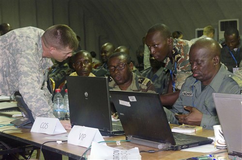 Lt. Col. Jonathan Shine, commander, 4th Battalion, 1st Field Artillery Regiment, 3rd Brigade, 1st Armored Division, works  with central African military personnel during the preparation phase of Central Accord 2015 in Libreville, Gabon, May 14. Shine and his counterparts  developed a plan of action for events taking place during the exercise. CA 15 exercises mission command proficiency for UN peacekeeping operations, develops multinational logistical and communications capabilities, and improves regional ability to command, control and support forward deployed forces. Approximately 400 military personnel from member nations are scheduled to participate in the exercise. The exercise consists of one week of classroom-based academics and one week of a command post exercise. (U.S. Army Africa photo by Staff Sgt. Michael Folkerth)