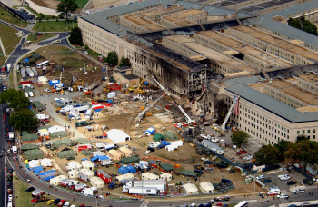 FBI agents, fire fighters, rescue workers and engineers work at the Pentagon crash site on Sept. 14, 2001, where a hijacked American Airlines flight slammed into the building on Sept. 11. The terrorist attack caused extensive damage to the west face of the building and followed similar attacks on the twin towers of the World Trade Center in New York City. DoD photo by Tech. Sgt. Cedric H. Rudisill.