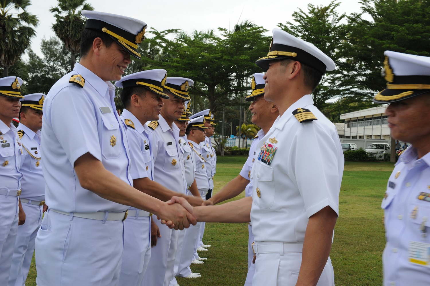 SATTAHIP, Thailand (Aug. 27, 2015) Capt. H.B. Le, commodore of Destroyer Squadron (DESRON) 7, shakes hands with Royal Thai Navy sailors at the opening ceremony of Cooperation Afloat Readiness and Training (CARAT) Thailand 2015. In its 21st year, CARAT is an annual, bilateral exercise series with the U.S. Navy, U.S. Marine Corps and the armed forces of nine partner nations.  U.S. Navy photo by Mass Communication Specialist 2nd Class Chelsy Alamina 