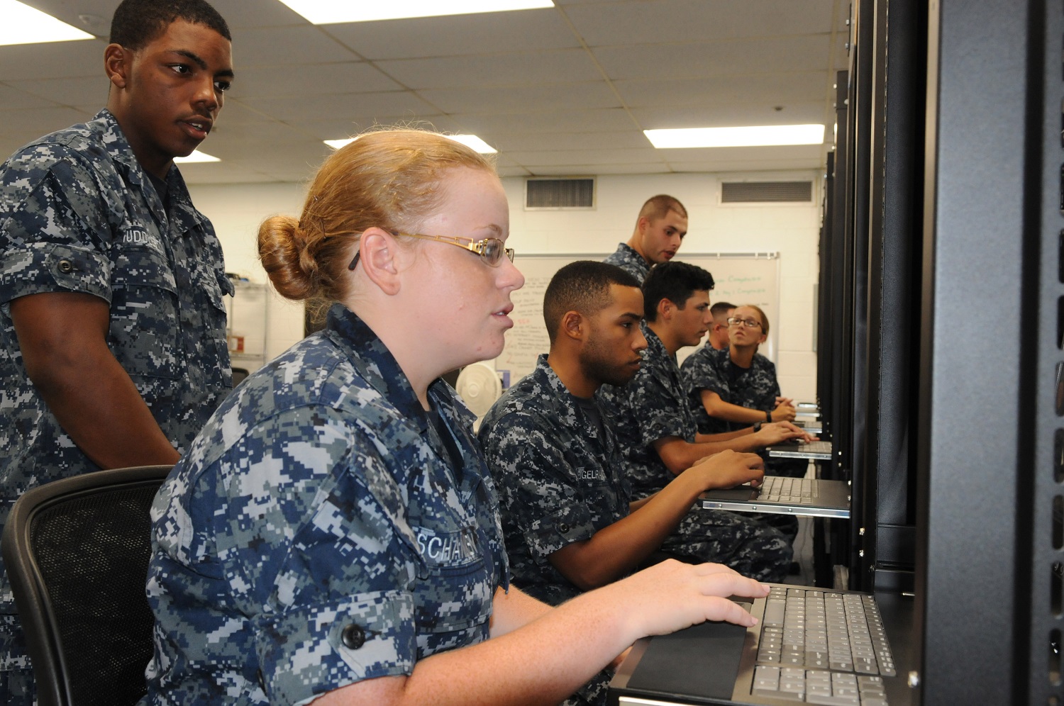 PENSACOLA, Fla. (July 31, 2015) Information systems technician students at the Center for Information Dominance Unit Corry Station set up a mock shipboard network. These students are part of the first Digital Tutor course, which is taught using an artificial-intelligence-based training method designed for the next generation of cyber warriors. The course teaches network administration, database management, and computer hardware and software troubleshooting skills.  U.S. Navy photo by Carla M. McCarthy 