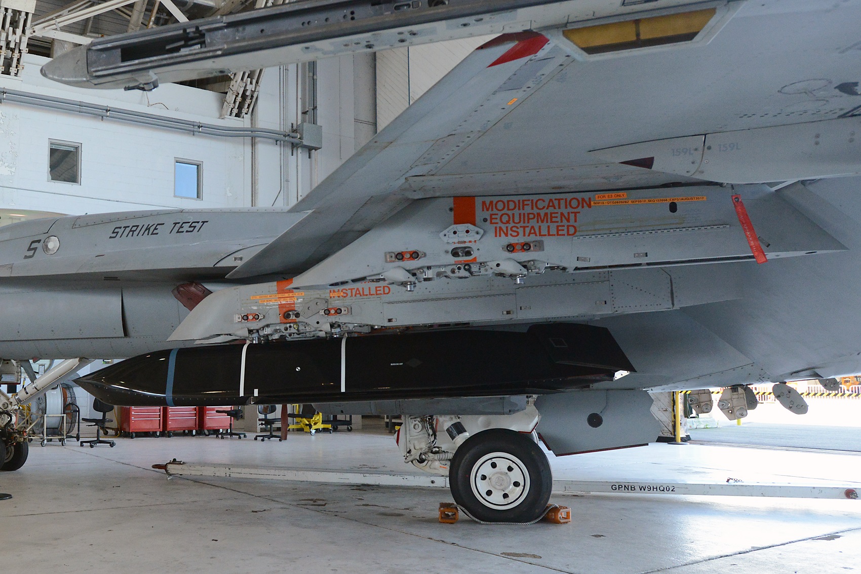 Initial fit checks are conducted on the Long Range Anti-Ship Missile (LRASM) Aug. 12 at NAS Patuxent River's Air Test and Evaluation Squadron (VX) 23 facility in preparation for the first phase of airworthiness testing with the F/A-18 E/F. U.S. Navy photo 