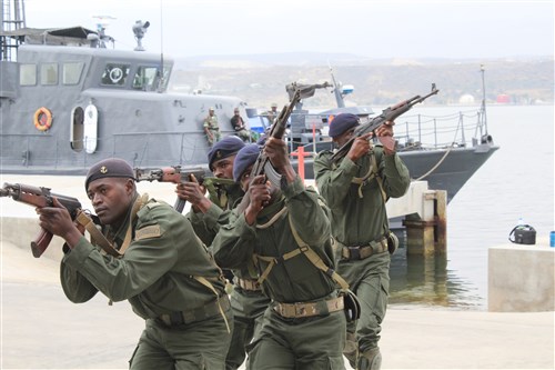 Angola's Fuzileiros Operaçües Especiais Marines prepare to clear buildings after disembarking a boat during room-clearing training, Oct. 7, in Lobito, Angola. U.S. Marines and U.K. Royal Marine Commandos trained the Fuzileiros Operaçües Especiais Marines as part of the Africa Partnership Station, which is a U.S Naval Forces Africa initiative that aims to increase the maritime safety and security capacity of African partners through collaboration, regional cooperation through engagement exercises that build toward self-sustained African security of the maritime domain. 