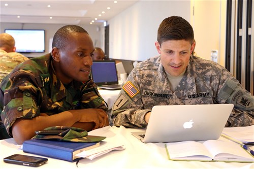 Capt. Joshua Dickinson, operational law attorney with U.S. Army Africa and Tanzanian People’s Defense Force attorney Capt. Mbwambo discuss work on the exercise support agreement during the final planning event for exercise Eastern Accord 2016 in Dar es Salaam, Tanzania, May 2. EA 2016 is an annual, combined, joint military exercise bringing together partner nations to practice and demonstrate proficiency in conducting peacekeeping operations. (U.S. Army Africa photo by Capt. Jarrod Morris)