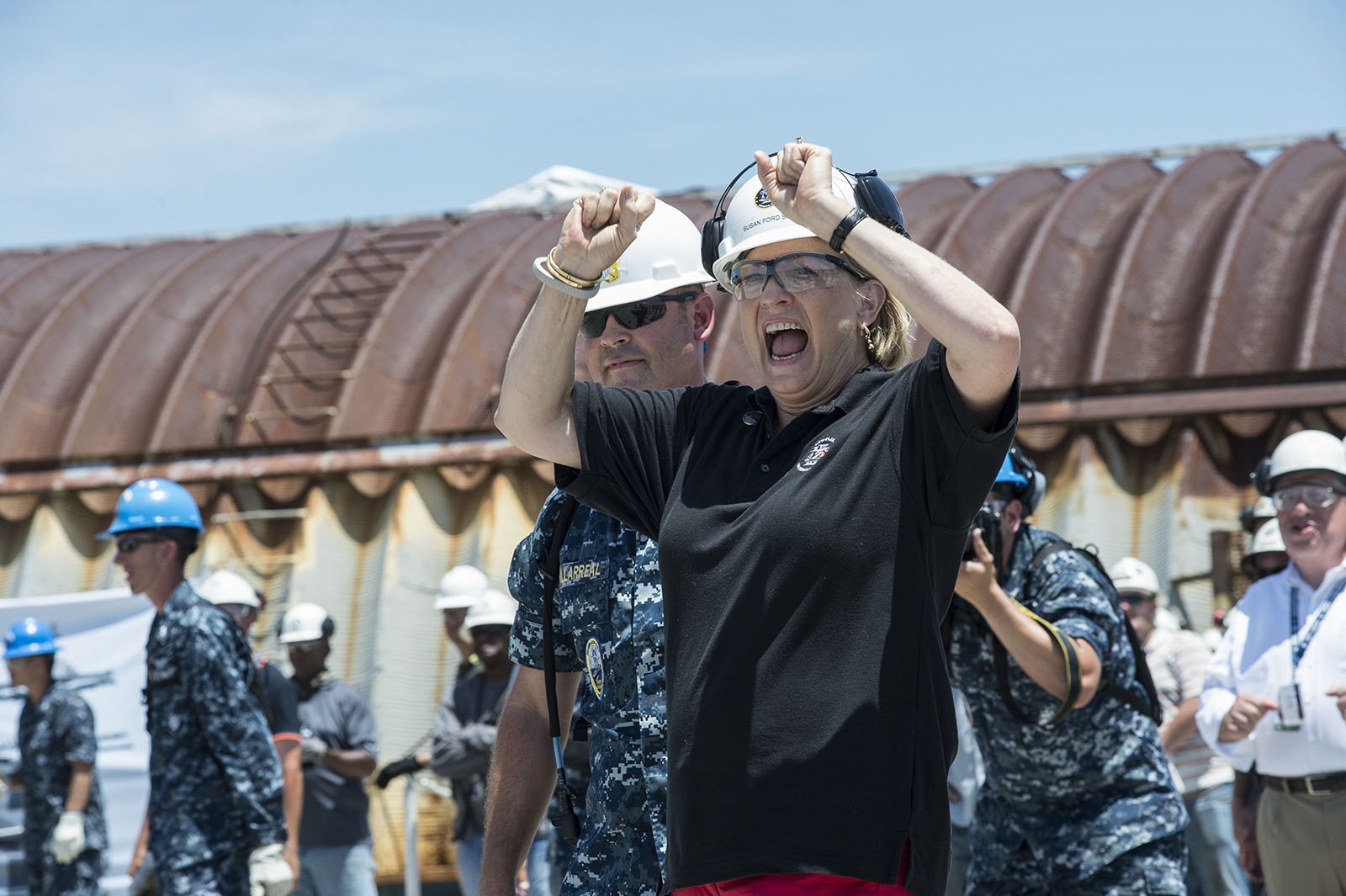 Aboard the aircraft carrier Pre-Commissioning Unit Gerald R. Ford (CVN 78), Susan Ford Bales, the ship's sponsor and daughter of the late President Ford for whom the ship is named, rejoices in in the first successful test launch of a dead-load sled from Electromagnetic Aircraft Launch System (EMALS) catapult number one June 16, 2015. Members of NAVAIR, the Naval Sea Systems Command, and crew of CVN 78 work together to ensure proper installation and testing of the system. EMALS has a wider energy range over the current steam-powered catapults. A wider energy range expands the Navy's future aircraft carrier operational capabilities, supporting the launch of the current and planned air wing composition — from lightweight unmanned aerial systems to heavy strike fighters. Photo courtesy Huntington Ingalls Industries.