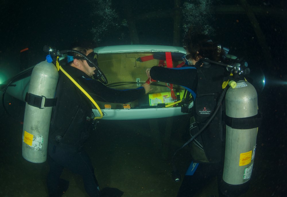WEST BETHESDA, Md. (June 22, 2015) Students from Texas A&M University perform an underwater inspection before racing their human powered submarine. The International Submarine Races look to inspire engineering students to delve into the broad areas of underwater technology and to provide an educational experience that translates their theoretical knowledge into reality. U.S. Navy Photo by Mass Communication Specialist 2nd Class Wyatt Huggett 