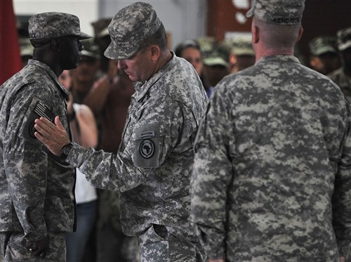 U.S. Maj. Gen. Mark Stammer, Combined Joint Task Force-Horn of Africa commanding general, presents Command Sgt. Maj. Butler Kendrick Jr. with the U.S. Africa Command combat patch during a ceremony at Camp Lemonnier, Djibouti, Nov. 28, 2015. The soldiers assigned to CJTF-HOA are now authorized to wear the U.S. Africa Command patch for the duration of their careers. (U.S. Air Force photo by Tech. Sgt. Dan DeCook)