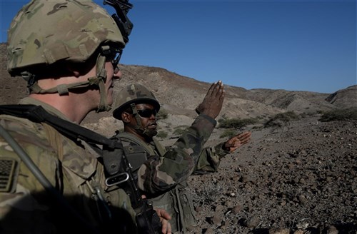 A French Army Soldier explains his plan to U.S. Army Sgt. Dare Crusade, 2-124 Seminole Battalion team leader, during a field training exercise March 16, 2016, in Arta, Djibouti. In addition to overcoming the language barrier, the Soldiers faced several challenges during the exercise such as lack of sleep, random ambushes from simulated opposing forces and serving in different positions in each other’s Army.