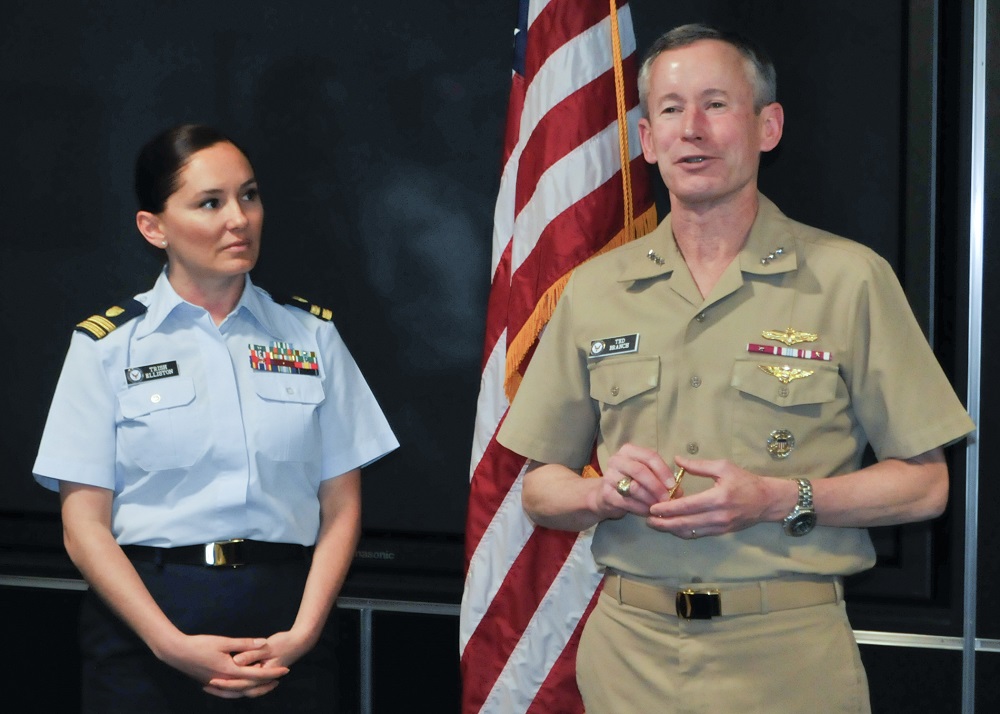 Arlington, VA (April 28, 2015) Vice Adm. Ted N. Branch, USN, deputy chief of Naval Operations for Information Dominance (N2/N6) recognizes U.S. Coast Guard Lieutenant Patricia Elliston at a Pentagon ceremony honoring her successful qualification as an Information Dominance Warfare Officer (IDWO). Lt. Ellison is the first Coast Guard officer and the first officer from another service to earn the IDWO pin. U.S. Navy photo by MC2 Kristin M. Schuster.