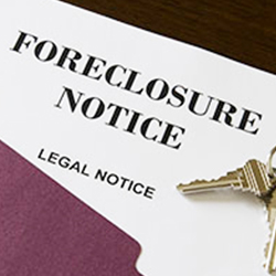 Foreclosure paperwork in a file folder with house keys on top