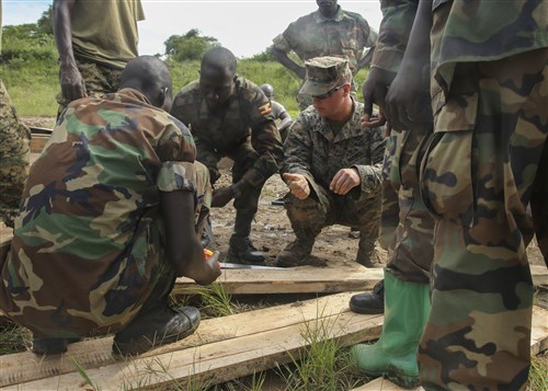 U.S. Marine Cpl. Brandon Ditmire, a combat engineer with Special-Purpose Marine Air-Ground Task Force Crisis Response-Africa, gives a thumbs-up to a Uganda People’s Defense Force soldier during a civil engineering exercise at Camp Singo, Nov. 16, 2015. The exercise helps the partner nations fortify their civil engineering skills while strengthening the bond between the two. (U.S. Marine Corps photo by Cpl. Olivia McDonald/Released)