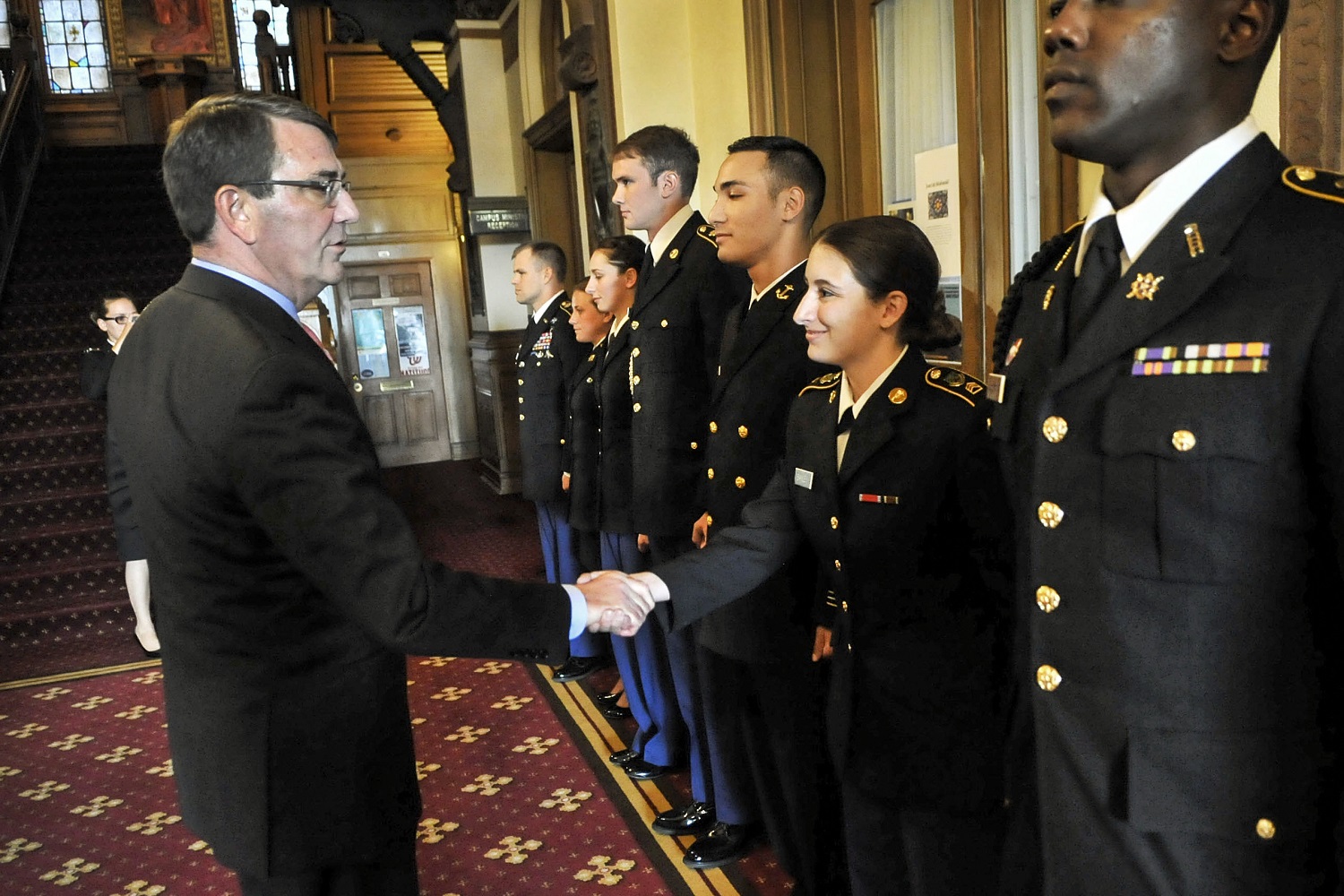 Defense Secretary Ash Carter shakes hands and gives his personal coin to ROTC members after delivering remarks on the Defense Department's efforts regarding sexual assault prevention and response at Georgetown University in Washington, D.C., April 22, 2015. DoD photo by Glenn Fawcett  

