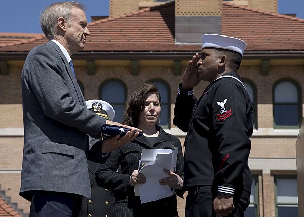 SPRINGFIELD, Ill. (April 15, 2015) Mass Communication Specialist 2nd Class Danian Douglas salutes Illinois Gov. Bruce Rauner after presenting him with a flag that was flown over President Abraham Lincoln's grave during a memorial service on the 150th anniversary of Lincoln's assassination. Sailors stationed aboard the Nimitz-class aircraft carrier USS Abraham Lincoln (CVN 72) are participating in events around the country honoring the passing of our 16th president. U.S. Navy photo by Mass Communication Specialist 3rd Class Evan Parker.
